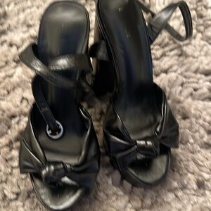 Black platforms with bow, unbranded, fits a 7 or 7.5.
